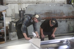 Jeff "JB" Bye, left, and David McDonough at Hylite Fabrication work on one of four AlumaSkis to go on tour in the lower 48 next month.